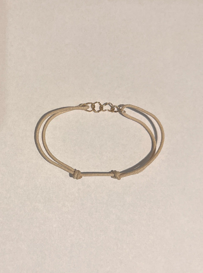Nordenstam - Bracelet with 4 gold rings Off-white